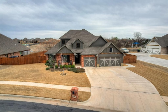 craftsman-style house featuring fence, an attached garage, a shingled roof, concrete driveway, and board and batten siding