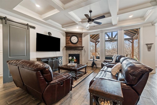 living room featuring beamed ceiling, wood finished floors, coffered ceiling, and ceiling fan