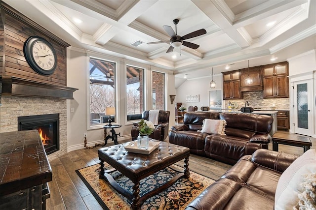 living room with visible vents, dark wood-type flooring, beamed ceiling, and a ceiling fan