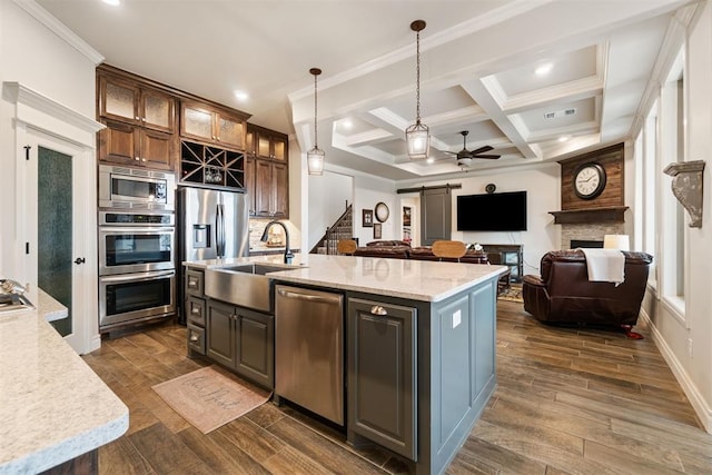 kitchen with a ceiling fan, a sink, coffered ceiling, stainless steel appliances, and wood tiled floor