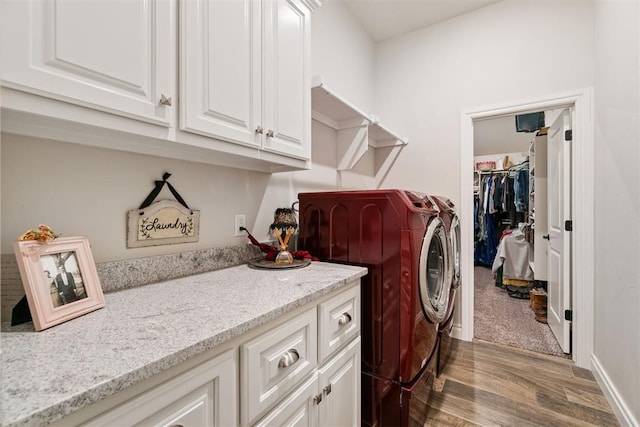 laundry room with wood finished floors, baseboards, and separate washer and dryer