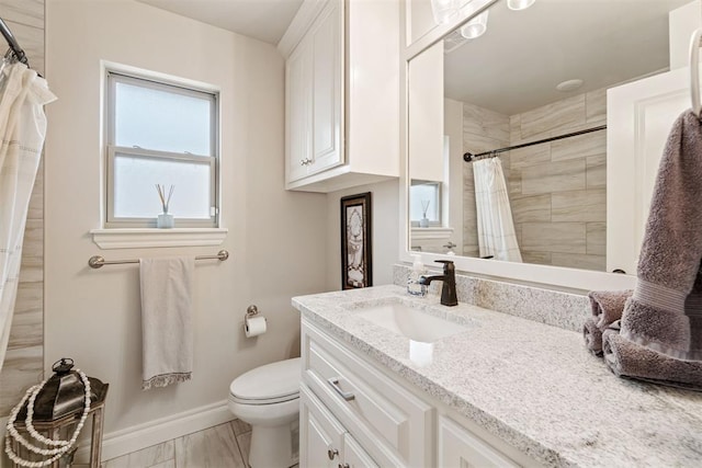 bathroom featuring curtained shower, toilet, vanity, and baseboards