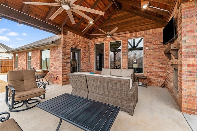 view of patio / terrace featuring an outdoor living space, a ceiling fan, and fence