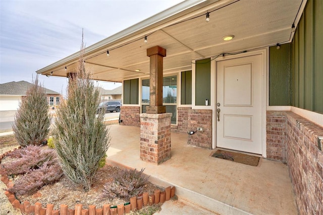 entrance to property featuring stone siding and a porch