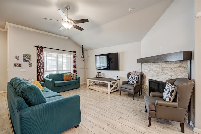 living area with a ceiling fan, baseboards, light wood finished floors, a stone fireplace, and vaulted ceiling