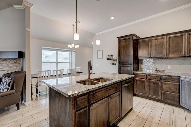 kitchen with dark brown cabinets, backsplash, stainless steel dishwasher, and a sink