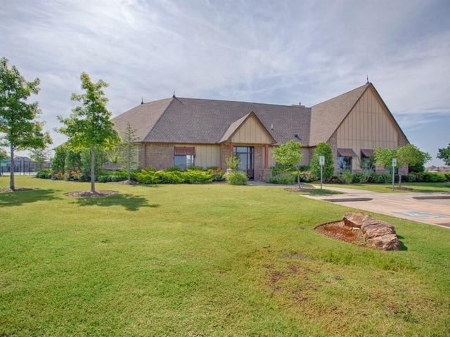 view of front of house with board and batten siding and a front yard