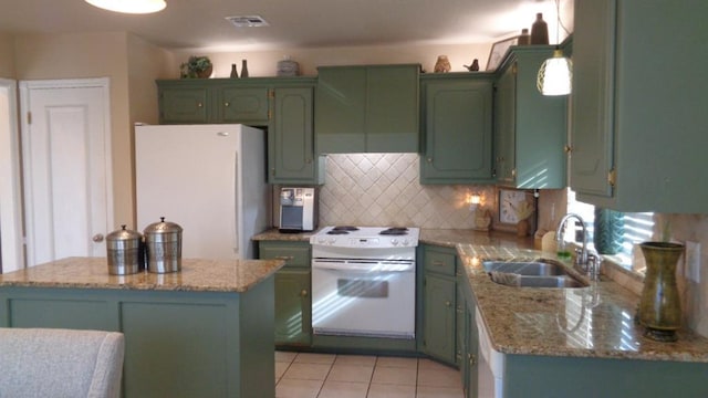 kitchen with backsplash, a kitchen island, green cabinets, white appliances, and a sink