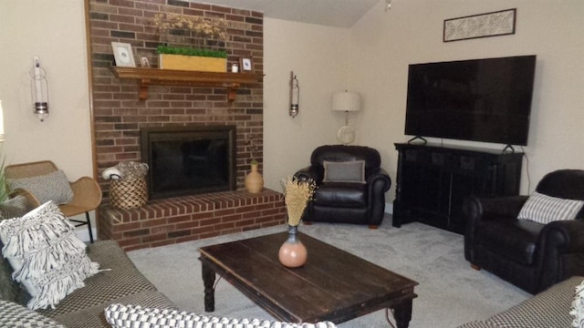 carpeted living area featuring a brick fireplace and vaulted ceiling