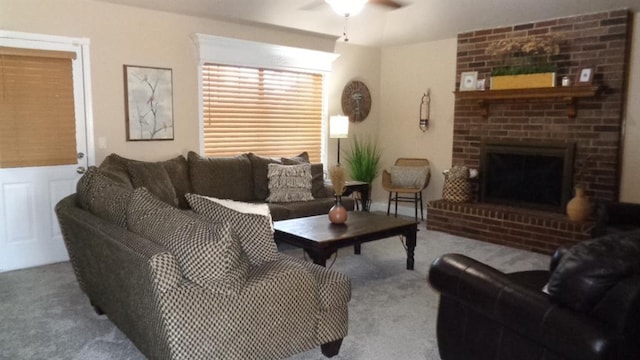 carpeted living room featuring a ceiling fan and a fireplace