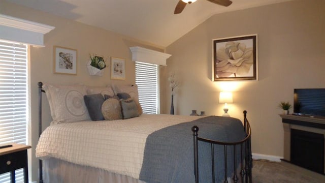 bedroom with lofted ceiling, multiple windows, carpet, and ceiling fan