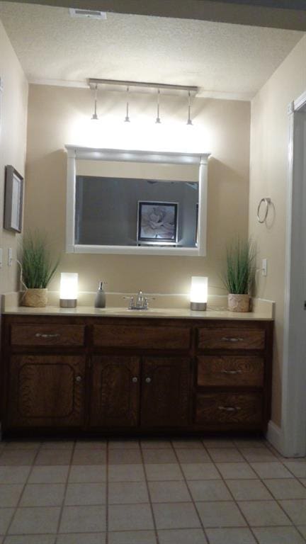 bathroom with vanity, tile patterned floors, and a textured ceiling