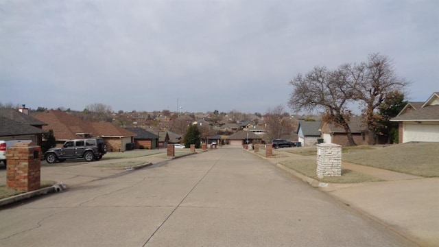 view of street featuring sidewalks, curbs, and a residential view