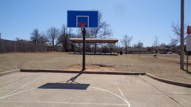 view of basketball court featuring fence