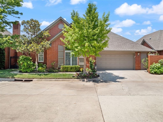 view of front facade with brick siding, concrete driveway, and an attached garage