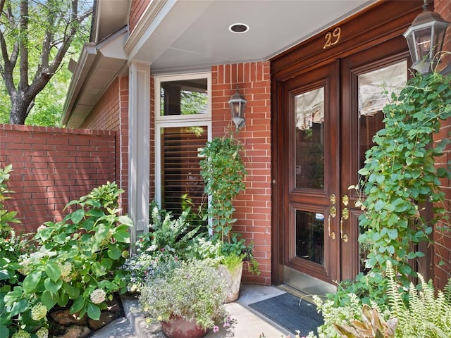 entrance to property featuring brick siding and french doors