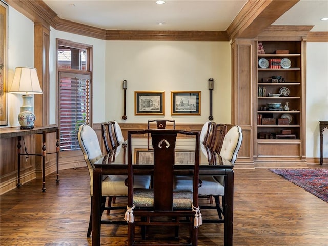 dining space with dark wood finished floors, recessed lighting, built in shelves, and ornamental molding