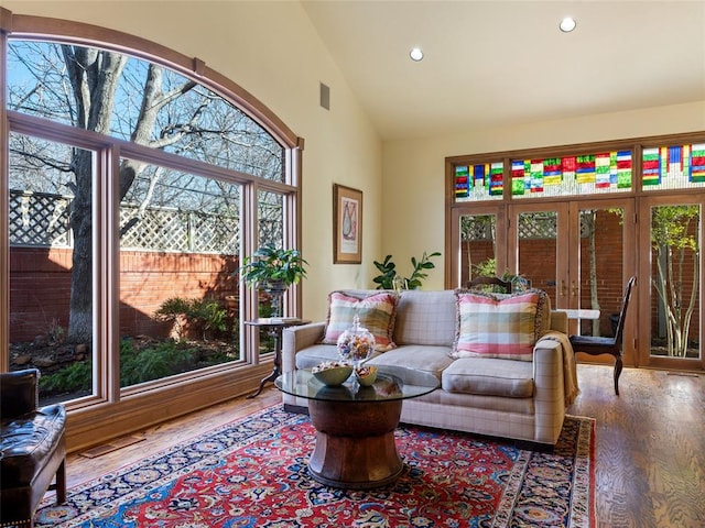 living room featuring visible vents, recessed lighting, high vaulted ceiling, and wood finished floors