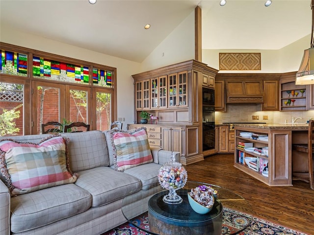 living room with dark wood-style floors, recessed lighting, and high vaulted ceiling