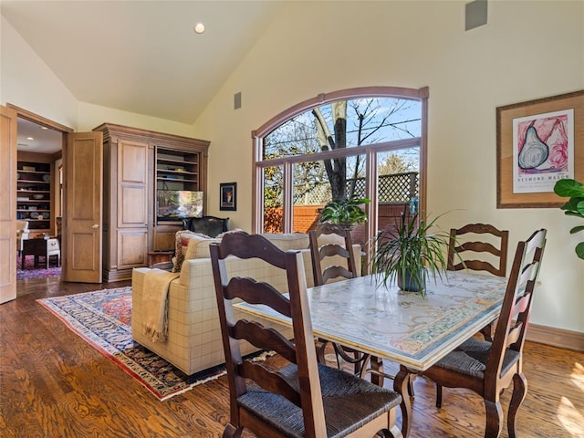 dining room featuring dark wood finished floors, recessed lighting, high vaulted ceiling, and baseboards