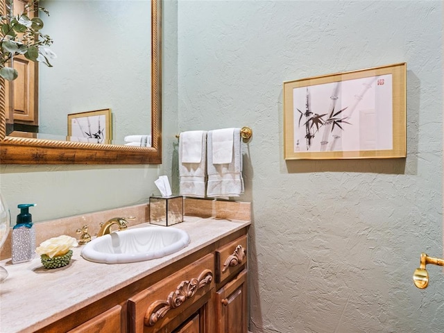 bathroom featuring vanity and a textured wall