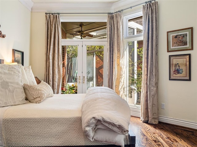 bedroom with access to exterior, ornamental molding, baseboards, and wood finished floors