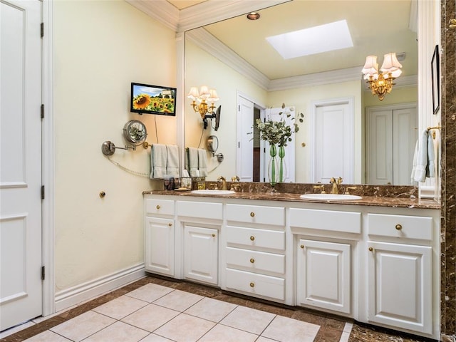 bathroom with a sink, a skylight, and crown molding