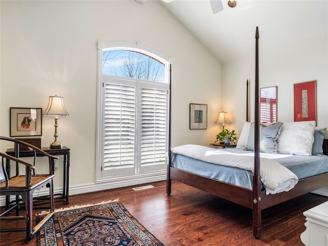 bedroom with lofted ceiling and wood finished floors