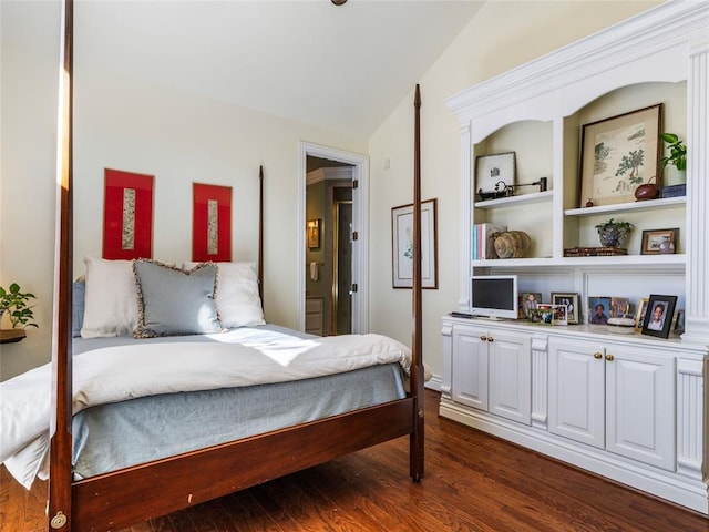 bedroom featuring dark wood-style floors and vaulted ceiling