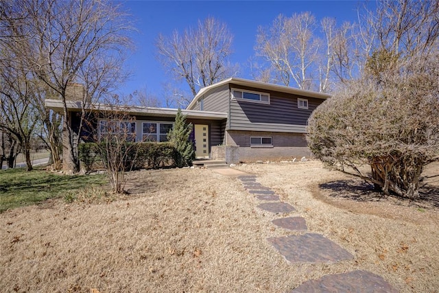 split level home featuring brick siding