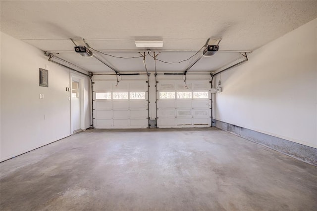 garage featuring electric panel and a garage door opener