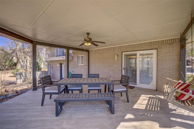 view of patio featuring outdoor dining area, a deck, and ceiling fan