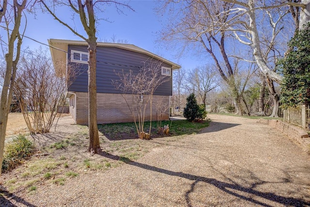 view of side of home with brick siding