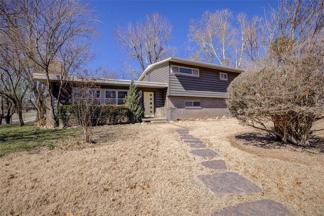 tri-level home with brick siding