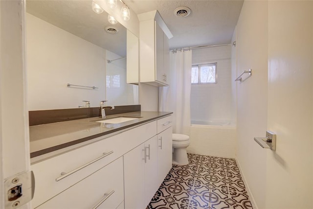 full bathroom with toilet, tiled shower / bath, visible vents, and vanity