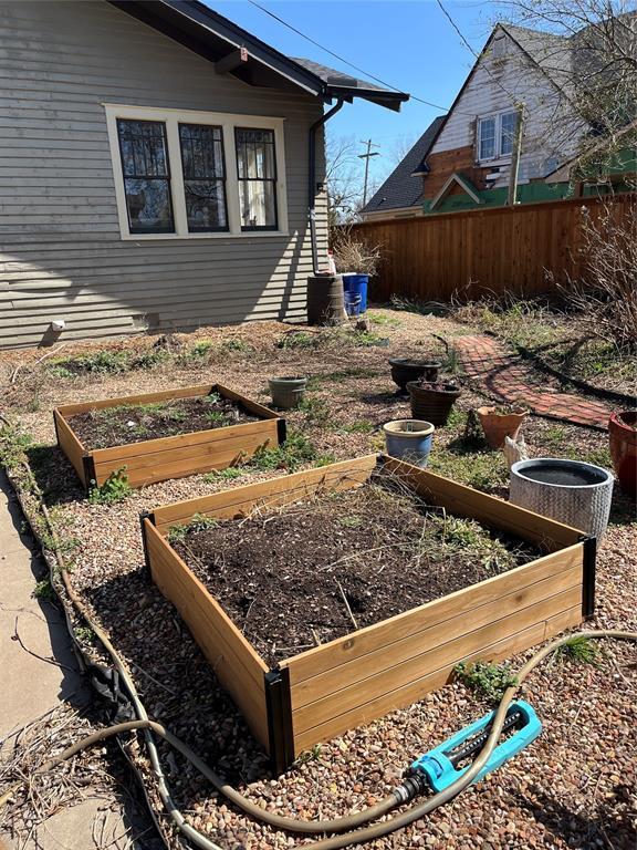 view of yard featuring a vegetable garden and fence