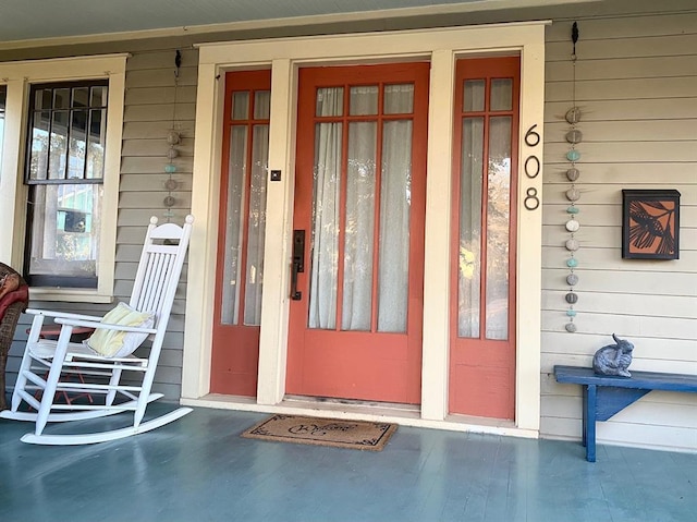 view of exterior entry featuring a porch