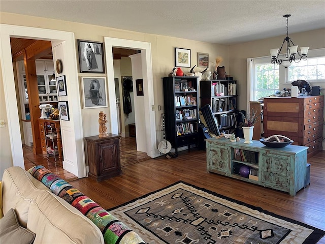 office space with a notable chandelier, a textured ceiling, and wood finished floors