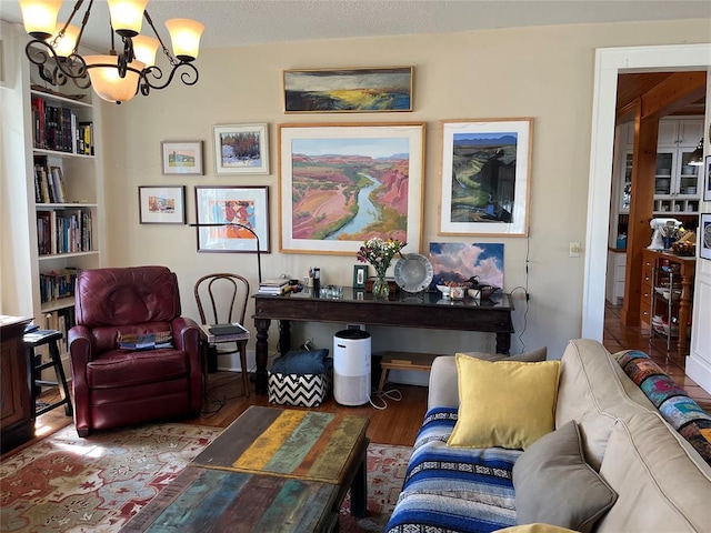 interior space with a notable chandelier, a textured ceiling, and wood finished floors