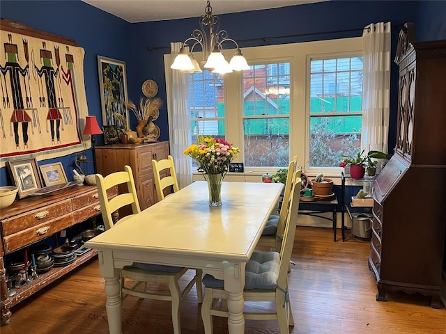 dining area featuring a notable chandelier and wood finished floors