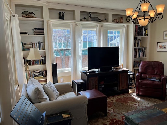 living room featuring built in shelves and a chandelier