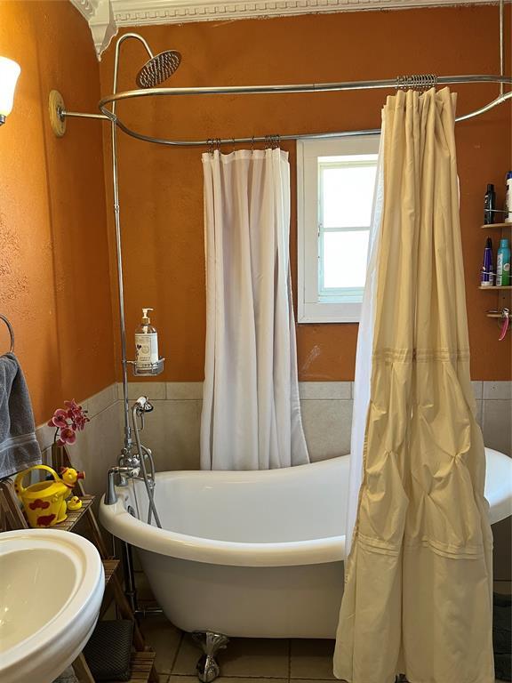 full bath with tile patterned flooring and a sink