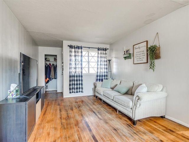 living room with light wood-type flooring and baseboards