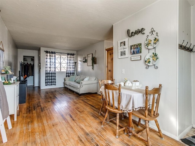 dining space featuring wood-type flooring