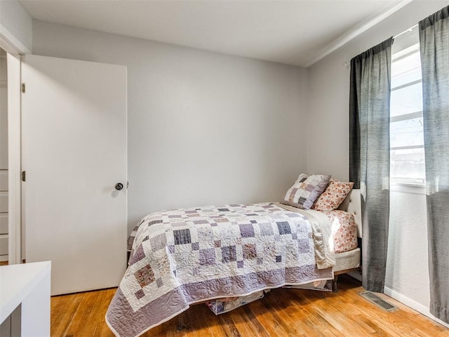 bedroom with wood finished floors and visible vents