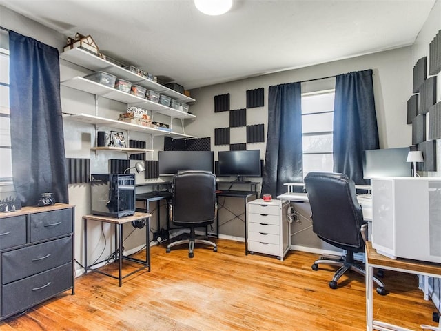 office space with baseboards and wood finished floors