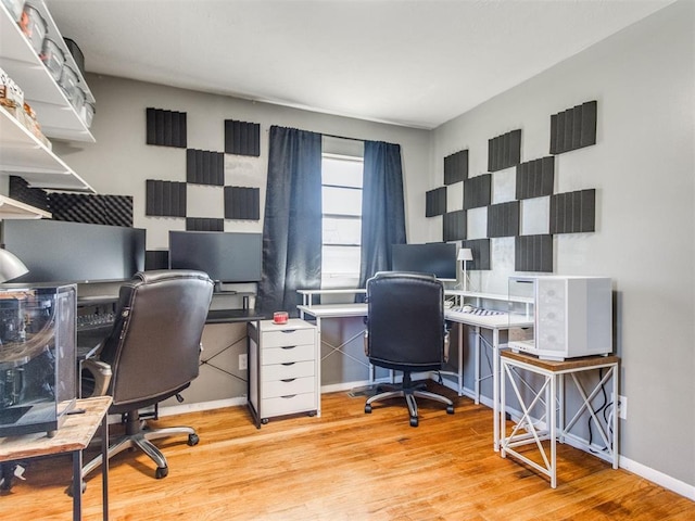 office space featuring light wood-type flooring and baseboards