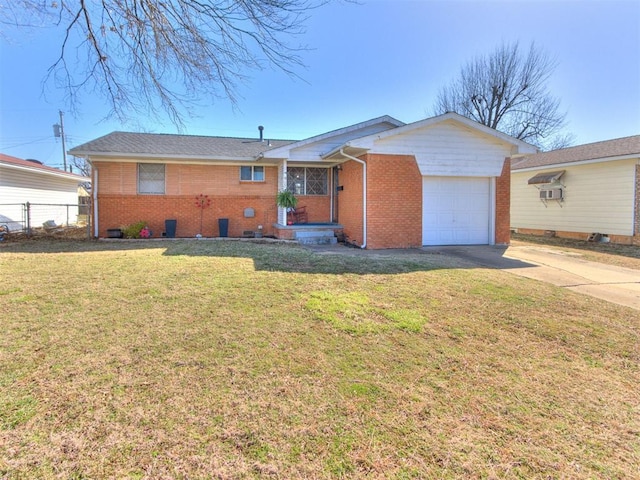 ranch-style home with fence, an attached garage, a front lawn, concrete driveway, and brick siding