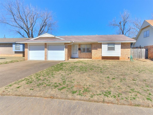 ranch-style house featuring brick siding, an attached garage, driveway, and a front lawn