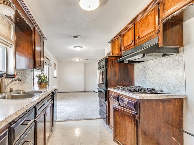 kitchen with a sink, visible vents, under cabinet range hood, and a healthy amount of sunlight